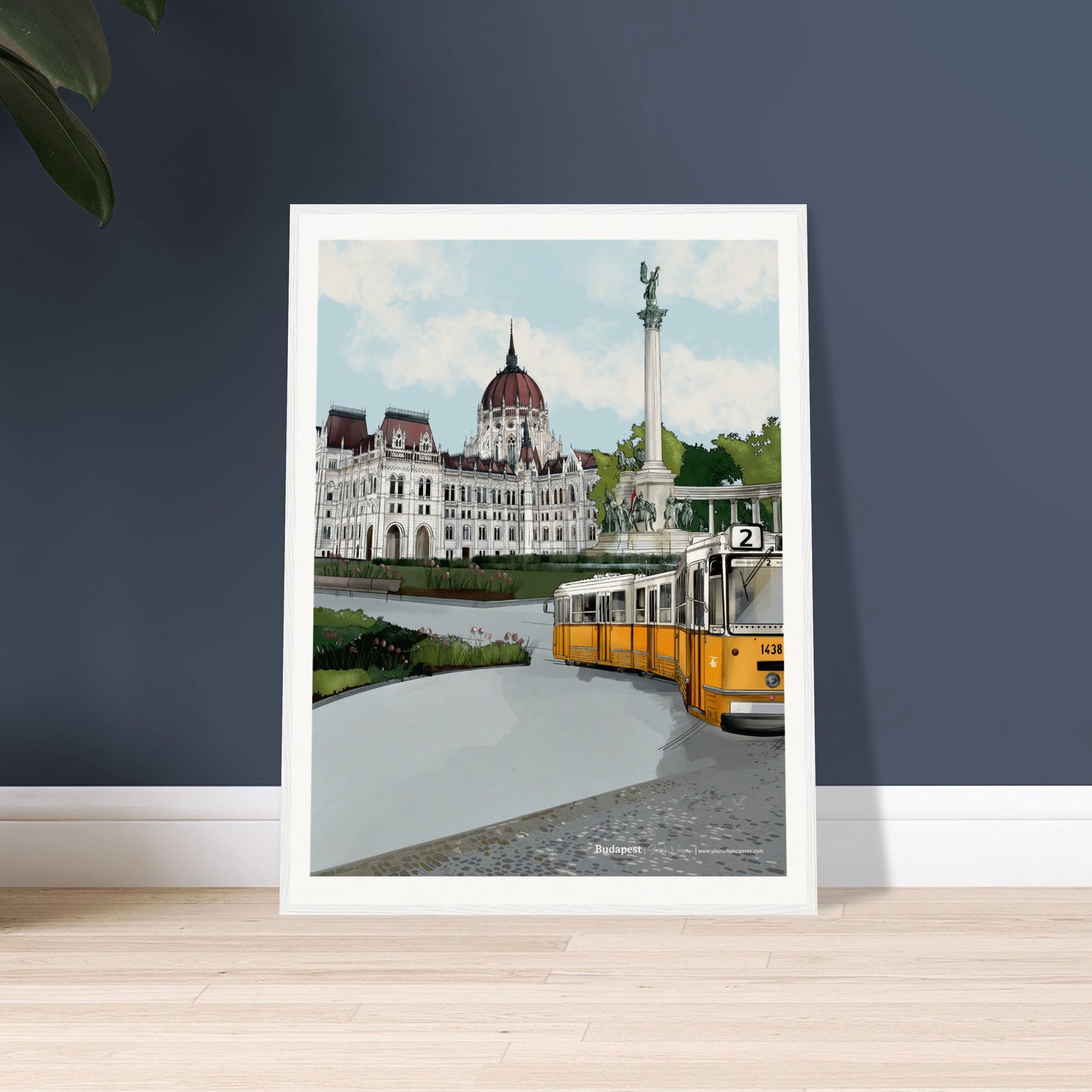 Immerse yourself in Budapest's beauty with a stunning artwork showcasing landmarks like the Parliament, Heroes' Square, and the famous yellow tram. White frame against dark wall gives the team the perfect pop of colour.