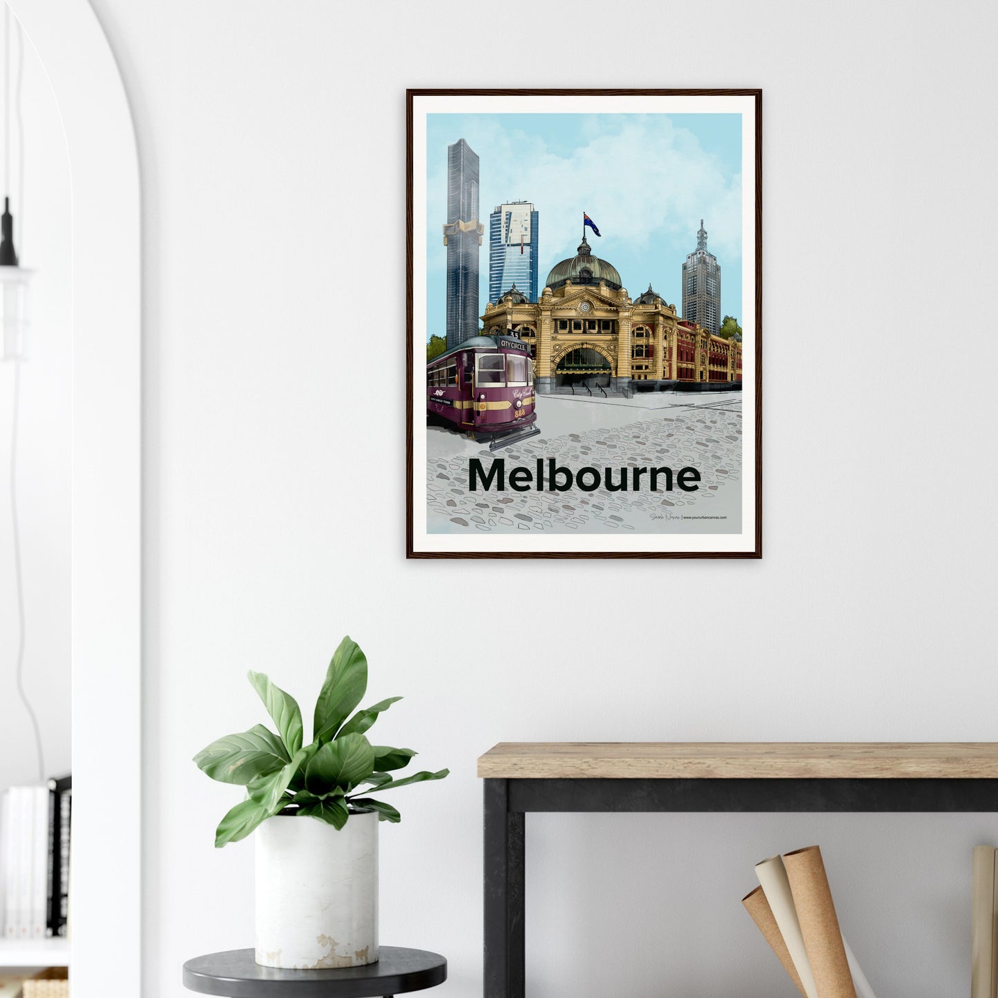 Modern interior showcasing a 60x80cm Melbourne city artwork hanging on the wall. Features a vibrant cityscape with Flinders Street Station, skyscrapers, and urban charm.