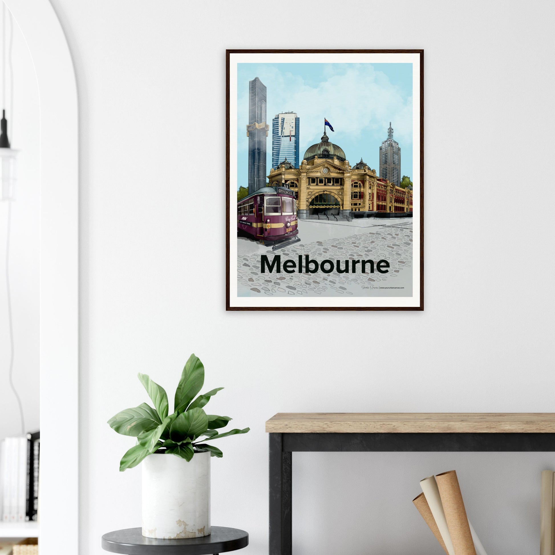 Modern interior showcasing a 60x80cm Melbourne city artwork hanging on the wall. Features a vibrant cityscape with Flinders Street Station, skyscrapers, and urban charm.