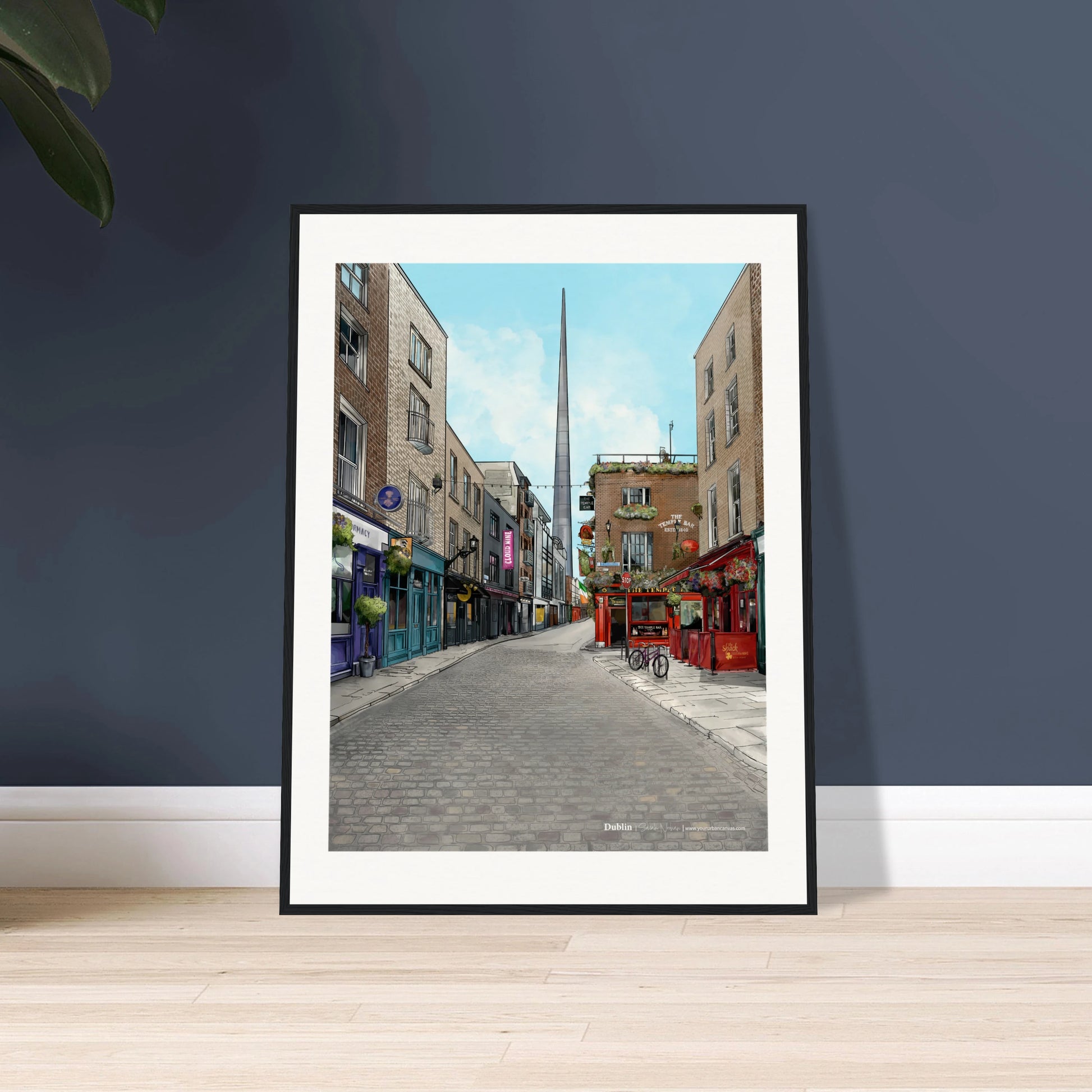 Framed art piece by artist Sarah Noonan of the cobbled streets of Temple Bar, the Temple Bar Inn, and the iconic Spire