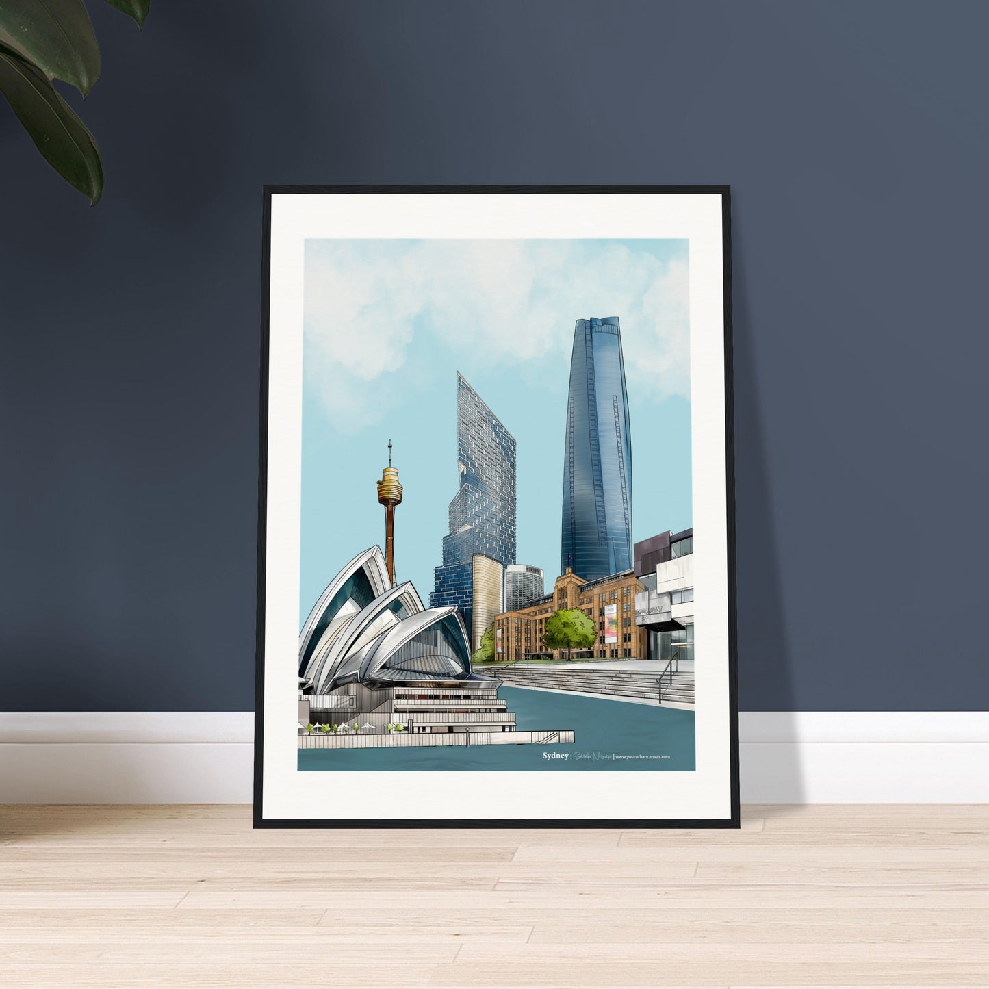 Framed artwork of a Sydney cityscape with  featuring the stunning Sydney Opera House, the Museum of Contemporary Art (MCA), Sydney Harbour, One Barangaroo, Quay Quarter Tower, and the Sydney Tower Eye in intricate detail displayed on a dark blue wall.